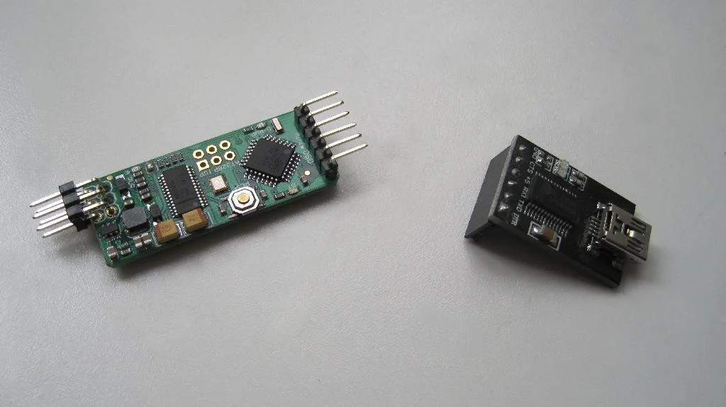 Адаптер USB-UART (FTDI) и minimOSD лежат на столе.